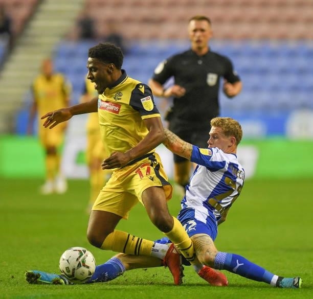 Bolton Wanderers' Oladapo Afolayan is fouled by Wigan Athletic's James McClean during the Carabao Cup Second Round match between Wigan Athletic and...