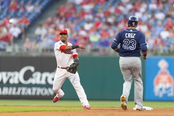 Jean Segura of the Philadelphia Phillies turns a double play against Nelson Cruz of the Tampa Bay Rays in the top of the first inning at Citizens...