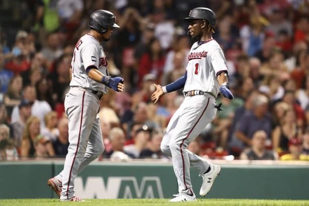 Nick Gordon of the Minnesota Twins high fives Luis Arraez of the Minnesota Twins after scoring in the fourth inning of a game against the Boston Red...