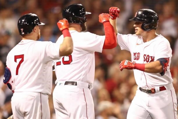 Hunter Renfroe of the Boston Red Sox high fives Travis Shaw of the Boston Red Sox after hitting a three-run home run in the fourth inning of a game...