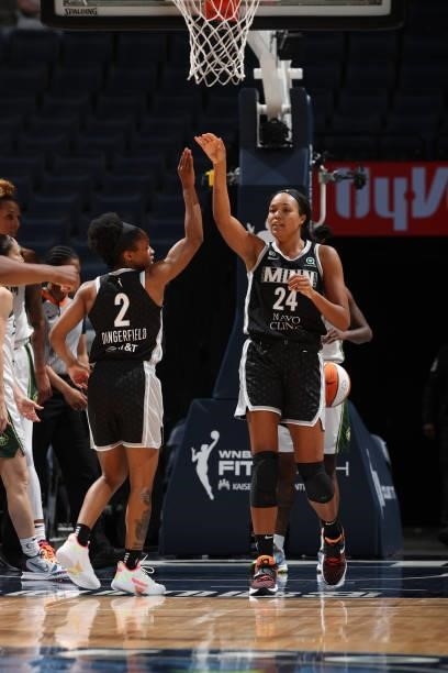 Napheesa Collier high fives Crystal Dangerfield of the Minnesota Lynx during the game against the Seattle Storm on August 24, 2021 at Target Center...