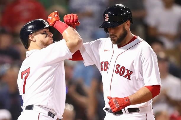 Travis Shaw of the Boston Red Sox high fives Christian Vazquez of the Boston Red Sox after hitting a solo home run in the fourth inning of a game...