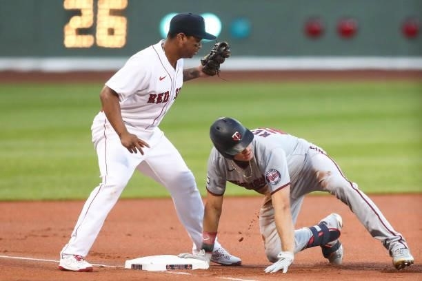 Max Kepler of the Minnesota Twins slides safely into their base for a triple in the first inning of a game against the Boston Red Sox at Fenway Park...
