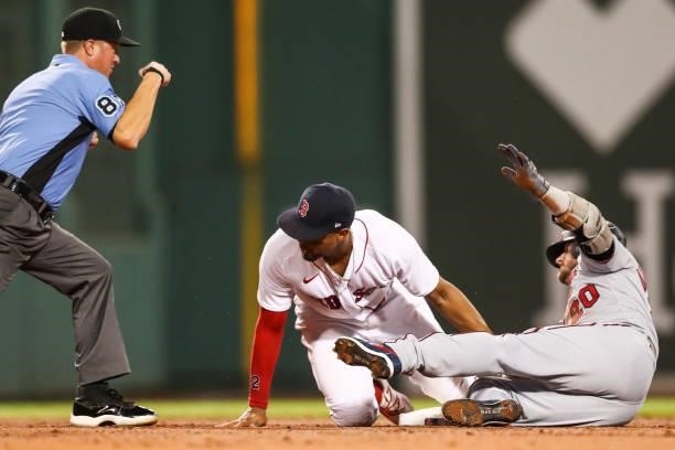 Josh Donaldson of the Minnesota Twins is tagged out at second base by Xander Bogaerts of the Boston Red Sox in the third inning of a game at Fenway...