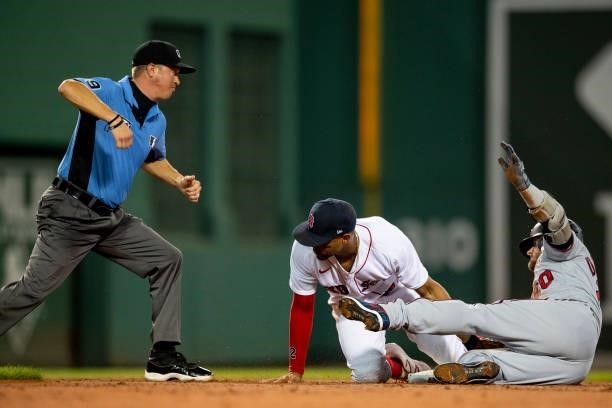 Josh Donaldson of the Minnesota Twins is tagged out by Xander Bogaerts of the Boston Red Sox during the third inning of a game on August 24, 2021 at...