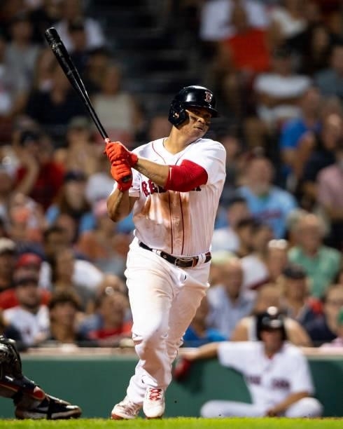 Rafael Devers of the Boston Red Sox hits a double during the fifth inning of a game against the Minnesota Twins on August 24, 2021 at Fenway Park in...