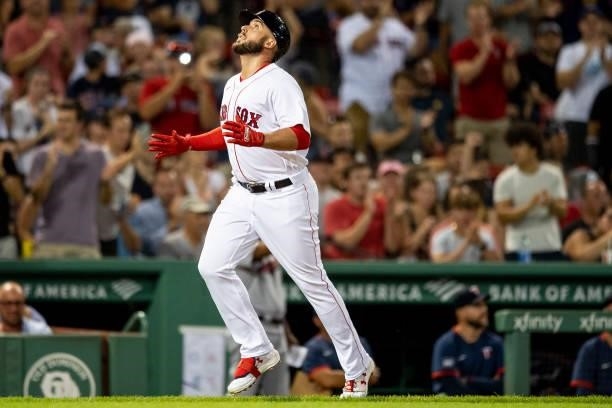 Travis Shaw of the Boston Red Sox reacts after hitting a solo home run during the third inning of a game against the Minnesota Twins on August 24,...
