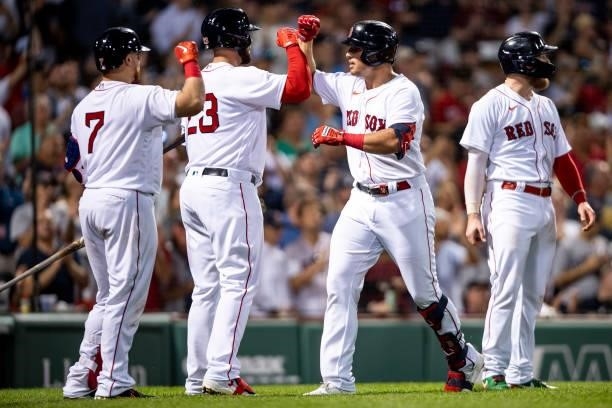 Hunter Renfroe of the Boston Red Sox reacts with Christian Vazquez, Travis Shaw, and Alex Verdugo after hitting a three-run home run during the...