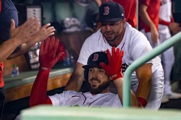 Travis Shaw of the Boston Red Sox is pushed in a cart by Kevin Plawecki after hitting a solo home run during the third inning of a game against the...