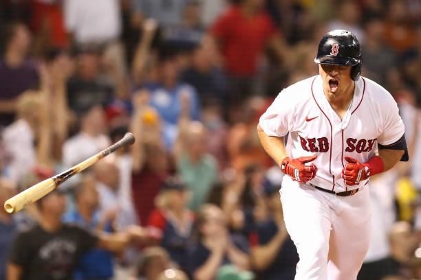 Hunter Renfroe of the Boston Red Sox tosses his bat after hitting a solo home run in the fifth inning of a game against the Minnesota Twins at Fenway...