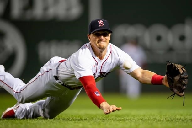 Enrique Hernandez of the Boston Red Sox dives for a ground ball during the inning of a game against the Minnesota Twins on August 24, 2021 at Fenway...