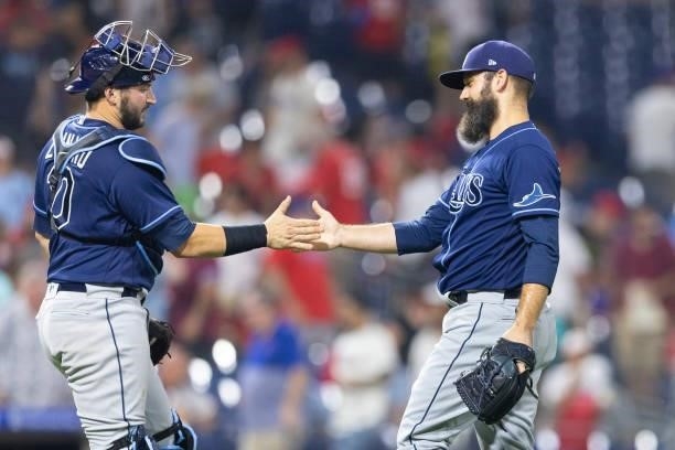 Mike Zunino and Andrew Kittredge of the Tampa Bay Rays celebrate their win against the Philadelphia Phillies at Citizens Bank Park on August 24, 2021...