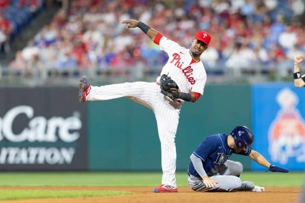Jean Segura of the Philadelphia Phillies turns a double play against Brandon Lowe of the Tampa Bay Rays in the bottom of the fourth inning at...
