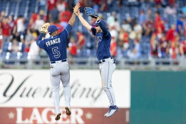Wander Franco of the Tampa Bay Rays high fives Brett Phillips after the game against the Philadelphia Phillies at Citizens Bank Park on August 24,...