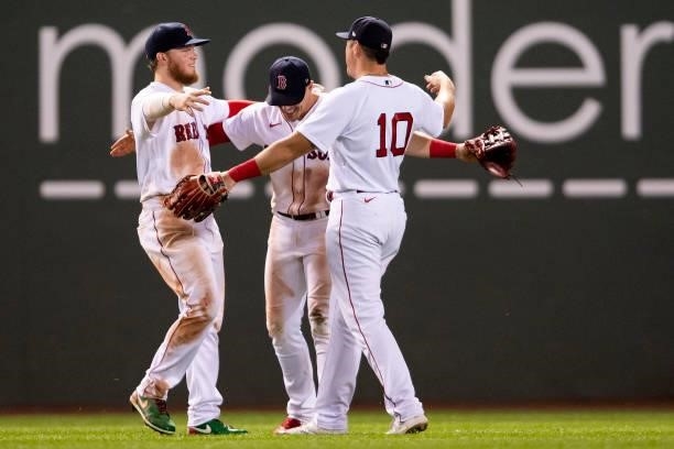 Alex Verdugo, Enrique Hernandez and Hunter Renfroe of the Boston Red Sox celebrate a victory against the Minnesota Twins on August 24, 2021 at Fenway...