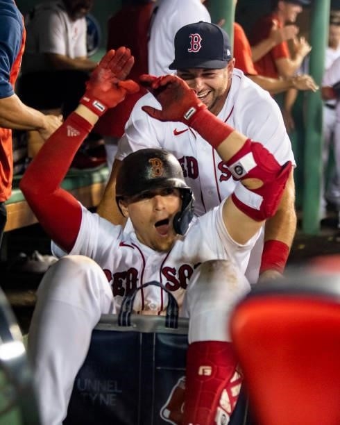Enrique Hernandez of the Boston Red Sox is pushed in a cart by Kevin Plawecki after hitting a two-run home run during the eighth inning of a game...
