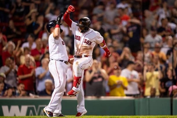 Enrique Hernandez of the Boston Red Sox reacts with Christian Vazquez after hitting a two-run home run during the eighth inning of a game against the...