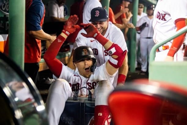 Enrique Hernandez of the Boston Red Sox is pushed in a cart by Kevin Plawecki after hitting a two-run home run during the eighth inning of a game...