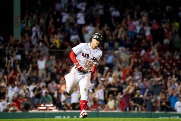 Enrique Hernandez of the Boston Red Sox reacts after hitting a two-run home run during the eighth inning of a game against the Minnesota Twins on...