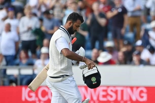 India's Cheteshwar Pujara walks back to the pavilion after getting out on the first day of the third cricket Test match between England and India at...