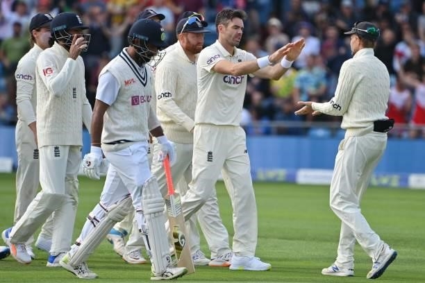 England's James Anderson celebrates with England's captain Joe Root after taking the wicket of India's Cheteshwar Pujara on the first day of the...