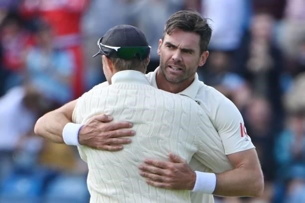 England's James Anderson celebrates taking the wicket of India's captain Virat Kohli with England's captain Joe Root on the first day of the third...
