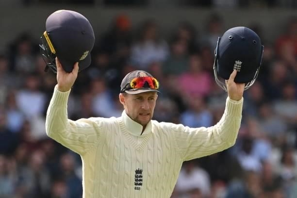 England's captain Joe Root gestures with two helmets on the first day of the third cricket Test match between England and India at Headingley cricket...