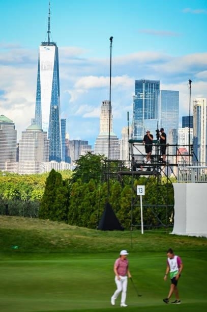 Cameron Smith of Australia walks off the 13th hole green with a view of the New York City skyline during the final round of THE NORTHERN TRUST, the...