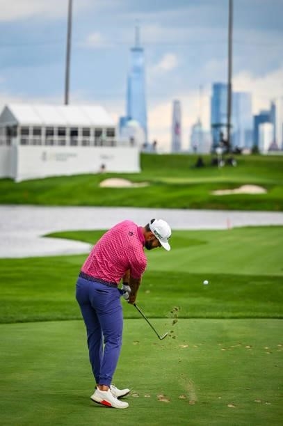 Erik van Rooyen of South Africa at impact as he plays his shot on the fourth hole towards the New York City skyline during the final round of THE...