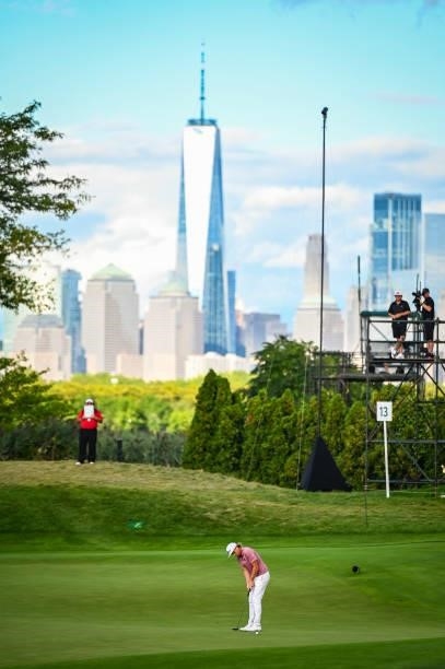 Cameron Smith of Australia putts for birdie on the 13th hole green with a view of the New York City skyline during the final round of THE NORTHERN...
