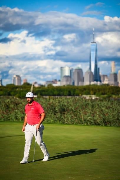 Jon Rahm of Spain walks off the 14th hole green with a view of the New York City skyline during the final round of THE NORTHERN TRUST, the first...