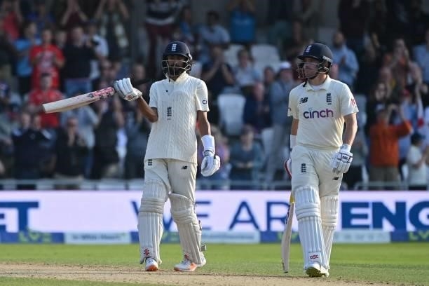 England's Haseeb Hameed celebrates his half-century with England's Rory Burns on the first day of the third cricket Test match between England and...