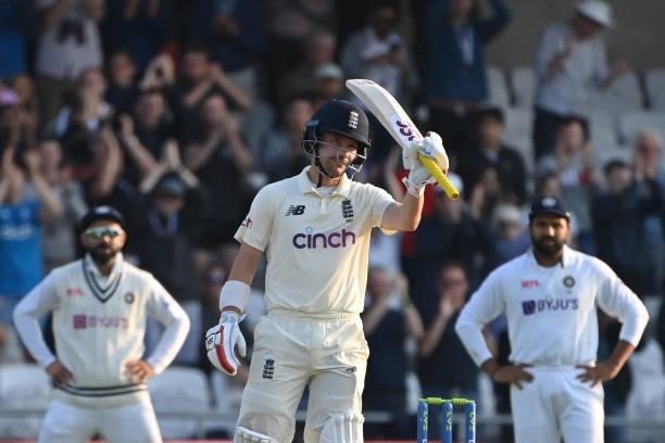 England's Rory Burns celebrates his half-century on the first day of the third cricket Test match between England and India at Headingley cricket...