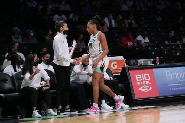 Assistant Coach, Jacki Gemelos high fives Betnijah Laney of the New York Liberty during the game against the Phoenix Mercury on August 25, 2021 at...