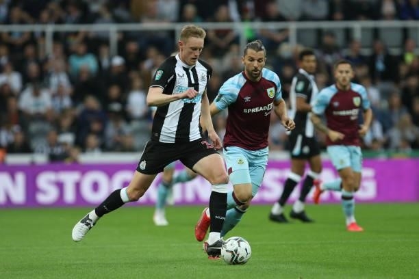 Sean Longstaff of Newcastle United and Jay Rodriguez of Burnley in action during the Carabao Cup match between Newcastle United and Burnley at St....