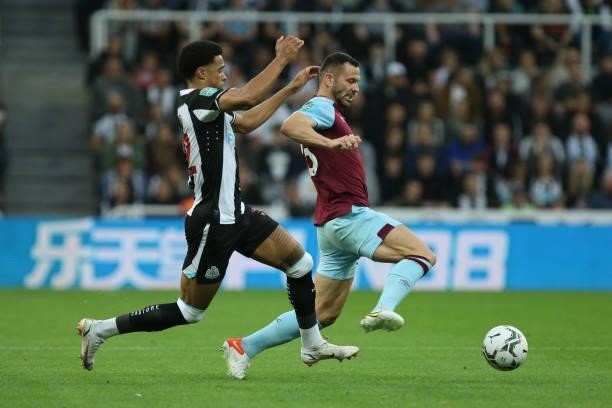 Jamal Lewis of Newcastle United and Phil Bardsley of Burnley in action during the Carabao Cup match between Newcastle United and Burnley at St....