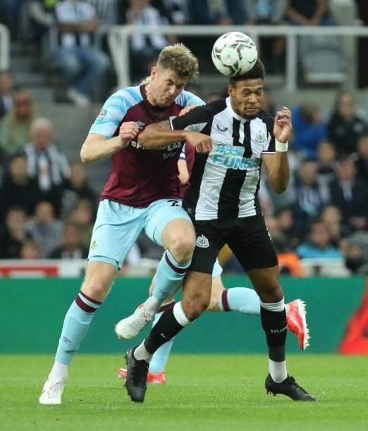 Joelinton of Newcastle United and Nathan Collins of Burnley in action during the Carabao Cup match between Newcastle United and Burnley at St....