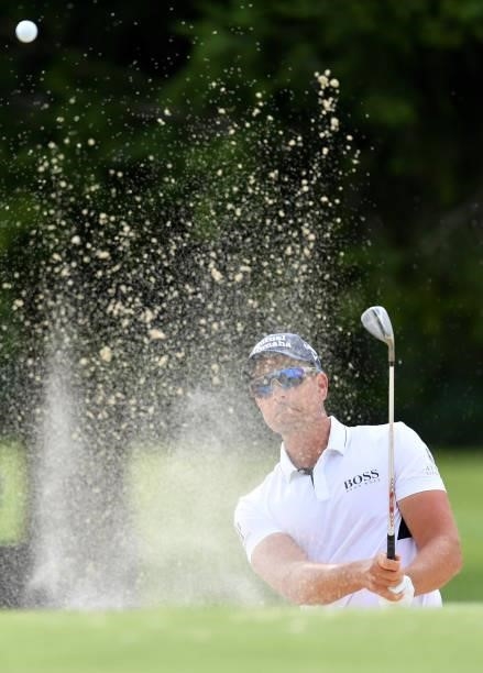 Henrik Stenson of Sweden plays a bunker shot at the 15th hole during Day One of The Omega European Masters at Crans-sur-Sierre Golf Club on August...
