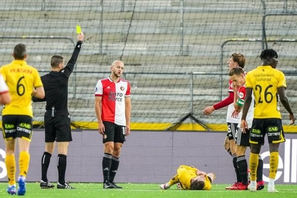 Referee Georgi Kabakov gives Gernot Trauner of Feyenoord a yellow card during the UEFA Conference League play-offs match between IF Elfsborg and...