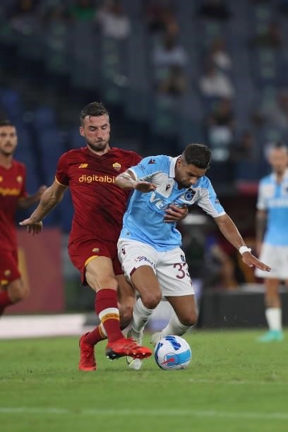 Bryan Cristante of AS Roma competes for the ball with Bruno Peres of Trabzonspor during the UEFA Conference League Play-Offs Leg Two match between AS...