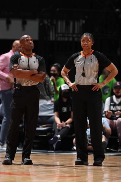 Referees, Eric Brewton and Toni Patillo look on during the game between the Seattle Storm and the Minnesota Lynx on August 24, 2021 at Target Center...