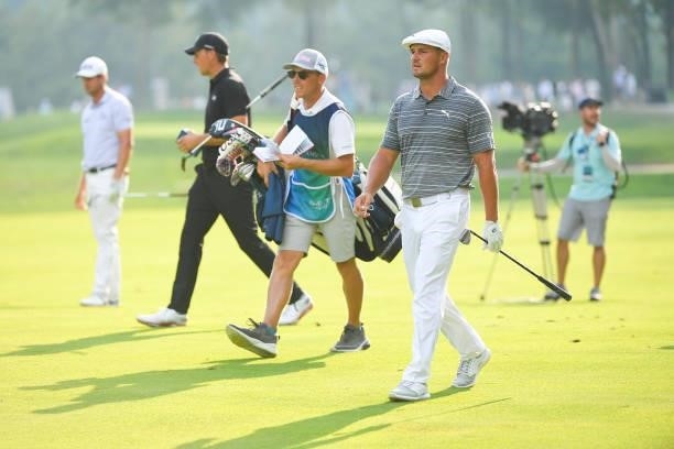 Bryson DeChambeau walks with his caddie along the 15th hole during the first round of the BMW Championship at Caves Valley Golf Club on August 26,...