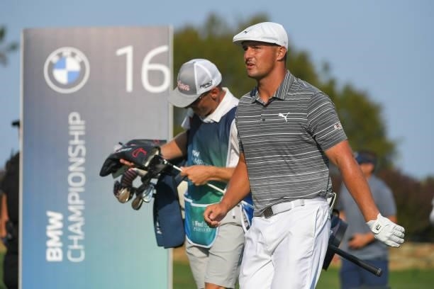 Bryson DeChambeau and his caddie walk off the 16th tee box during the first round of the BMW Championship at Caves Valley Golf Club on August 26,...