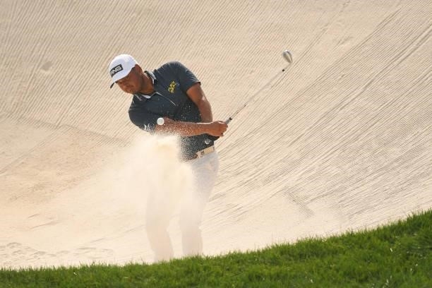 Sebastián Muñoz of Colombia hits a shot from the bunker on the 18th hole during the first round of the BMW Championship at Caves Valley Golf Club on...