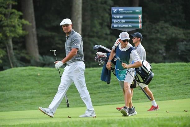 Bryson DeChambeau and his caddie walk along the 15th fairway during the first round of the BMW Championship at Caves Valley Golf Club on August 26,...