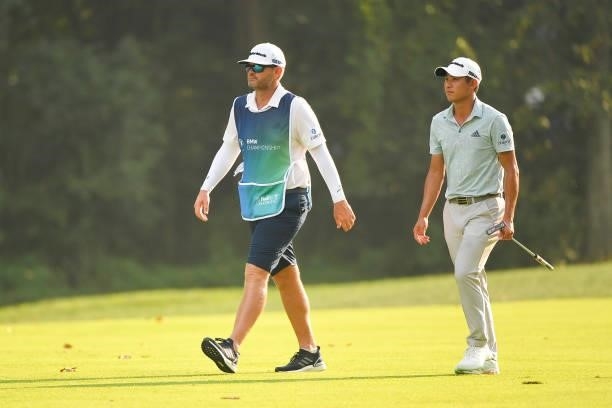 Collin Morikawa and his caddie walk along the 15th fairway during the first round of the BMW Championship at Caves Valley Golf Club on August 26,...
