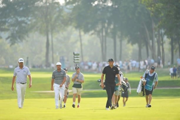 Harris English, Bryson DeChambeau and Jordan Spieth walk along the 15th fairway during the first round of the BMW Championship at Caves Valley Golf...