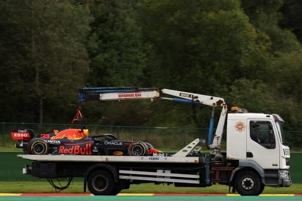Crane truck transports the car of Red Bull's Dutch driver Max Verstappen after he crashed during the second practice session of the Formula One...