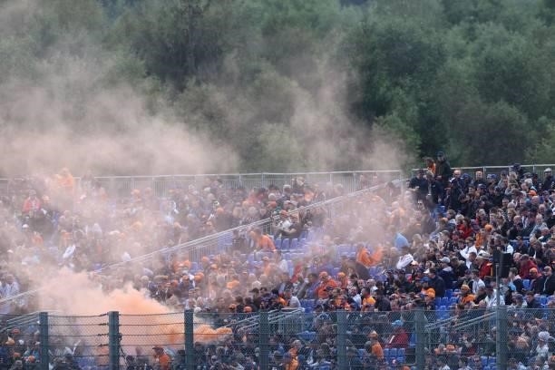 Spectators burn flares as they watch the second practice session of the Formula One Belgian Grand Prix at the Spa-Francorchamps circuit in Spa on...