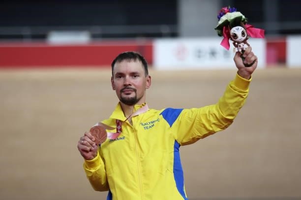 Bronze medalist Yehor Dementyev of Team Ukraine celebrates on the podium during the medal ceremony for the Track Cycling Men's C4 4000m Individual...